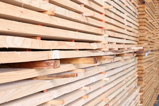 Close-up of stacked boards separated by stickers