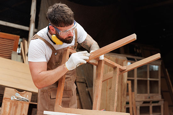 carpenter working on wood chair