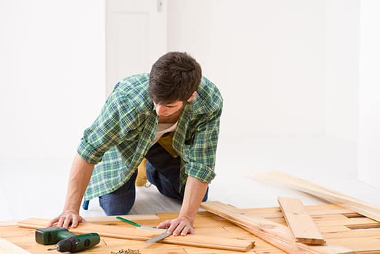 Handyman installing wood floor